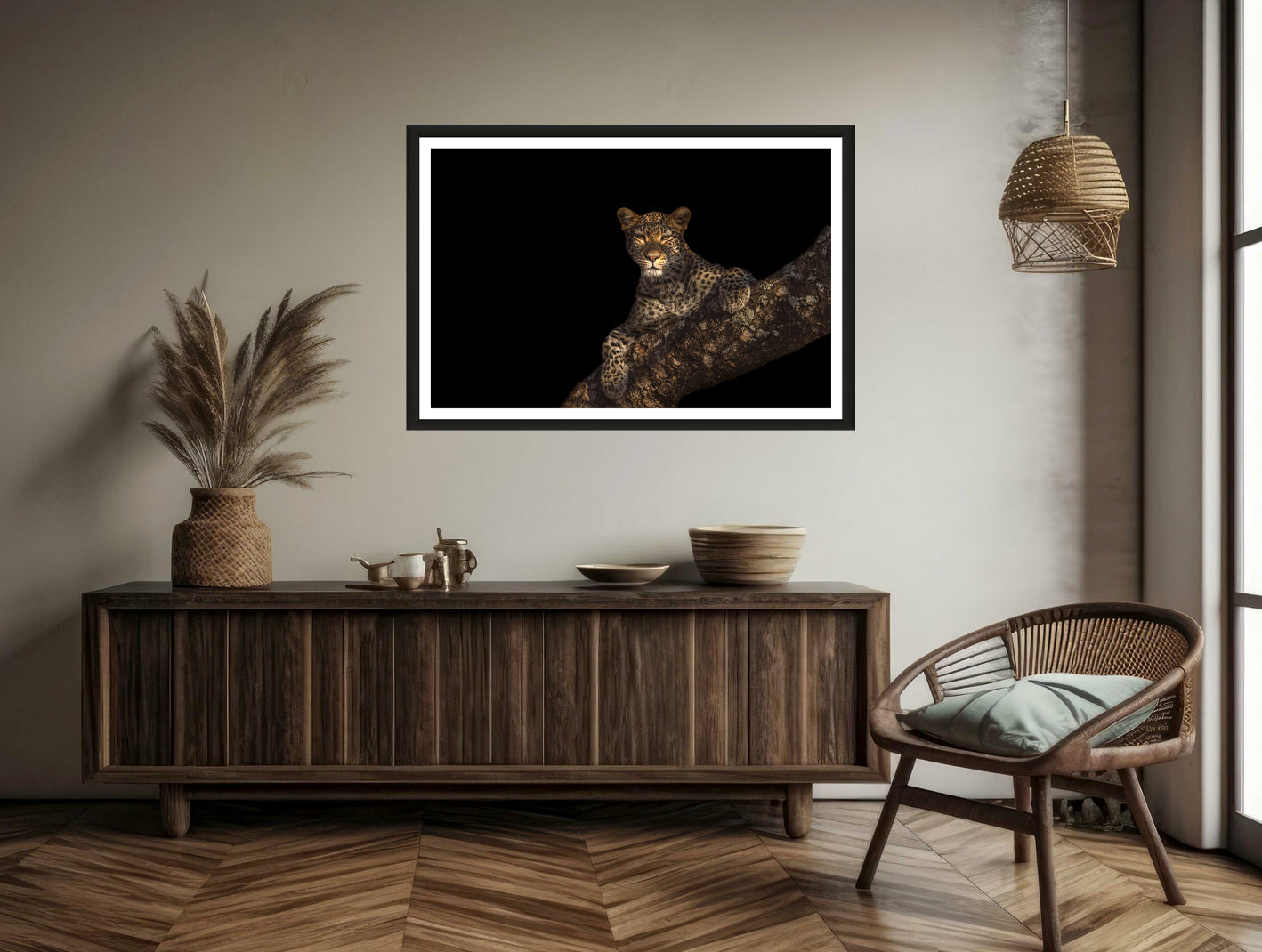 A photograph of a beautiful female leopard hanging over a huge Marula branch staring into the camera hanging on a brown wall above a chair and a commode.